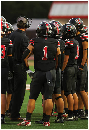 A group of football players celebrating a touchdown. Description generated by AI