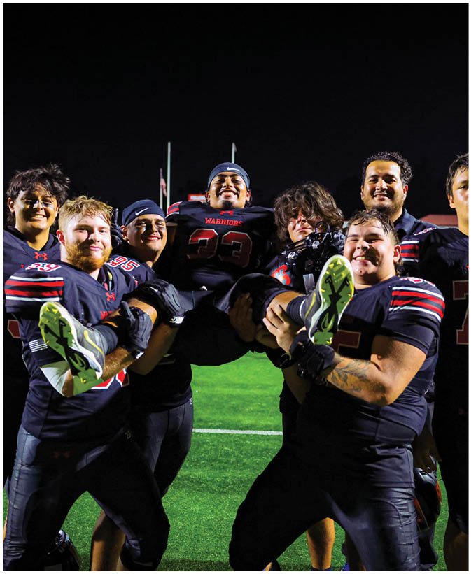 A group of football players on a field. Description generated by AI