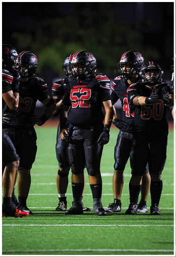 A group of football players celebrating a touchdown. Description generated by AI