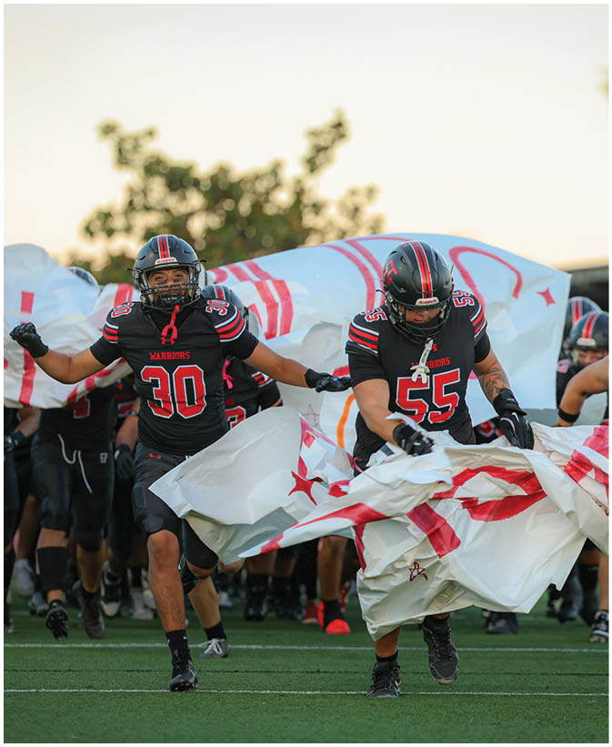 A group of football players on a field. Description generated by AI