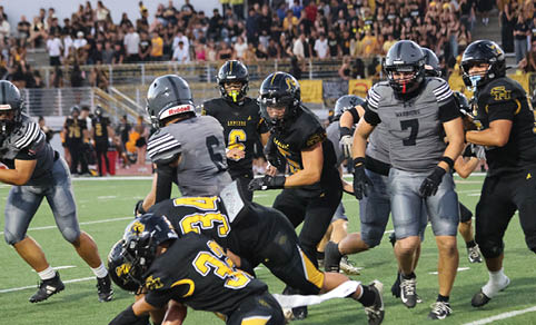 Two men wearing football uniforms are hugging each other on a field. AI generated content