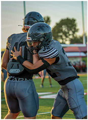 A football player wearing a blue jersey with the number 58 on it. Description generated by AI