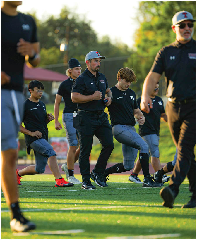A group of football players on a field. Description generated by AI