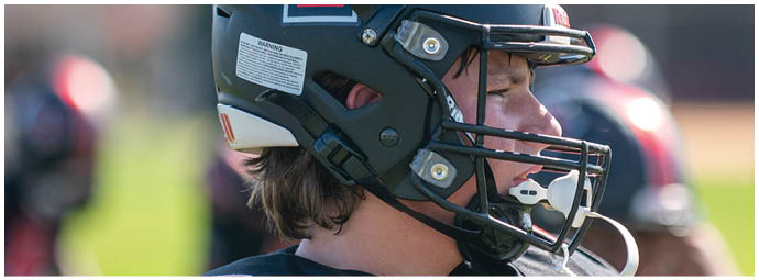 A football player wearing a blue and white uniform. Description generated by AI