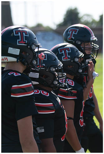 A football game is being played on a field. Description generated by AI