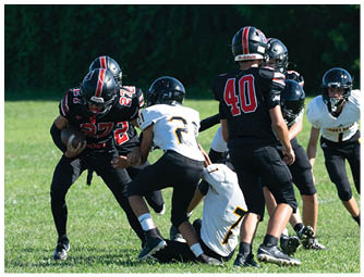 A group of football players on a field. Description generated by AI
