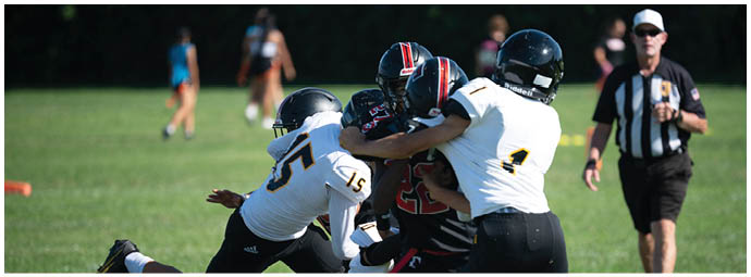 A football player wearing a blue and white uniform. Description generated by AI