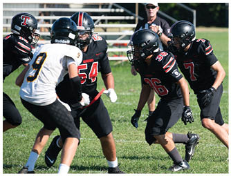 A group of football players on a field. Description generated by AI