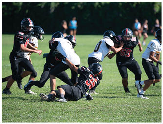 A group of football players on a field. Description generated by AI