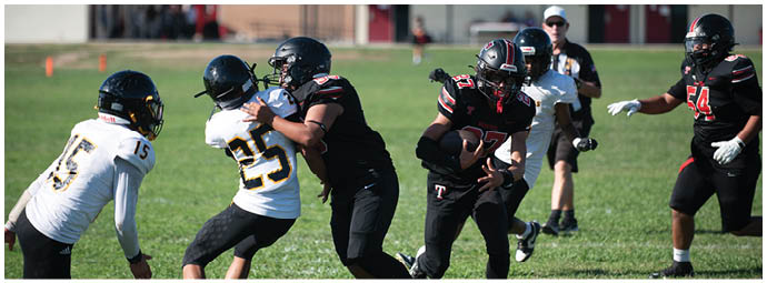 A football player wearing a blue and white uniform. Description generated by AI