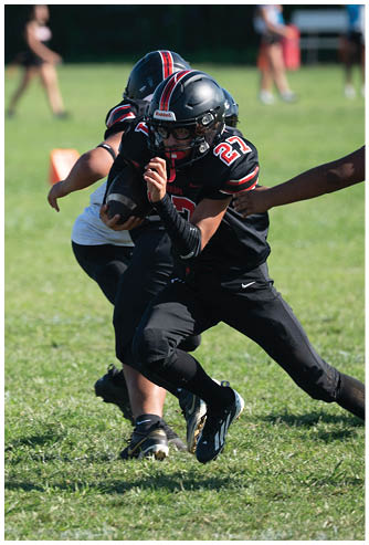 A football game is being played on a field. Description generated by AI