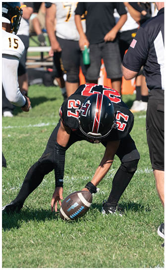 A football player catching a ball. Description generated by AI