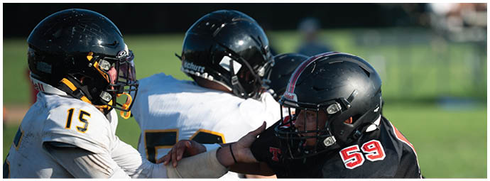 A football player wearing a blue and white uniform. Description generated by AI