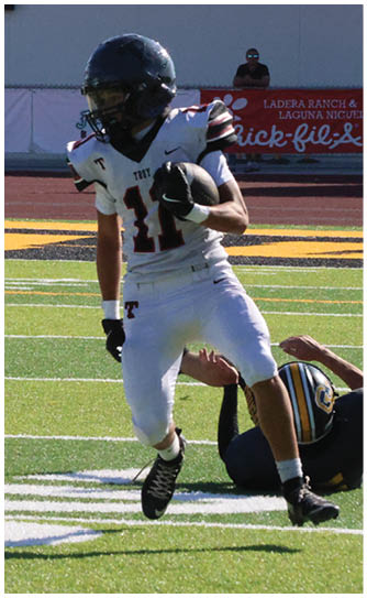 A football player catching a ball. Description generated by AI