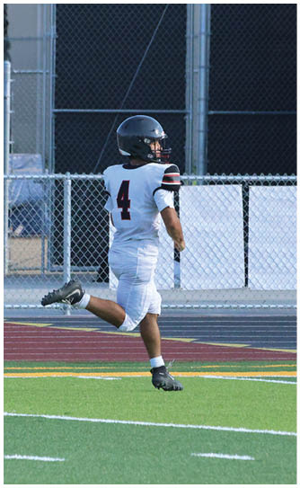 A football player catching a ball. Description generated by AI