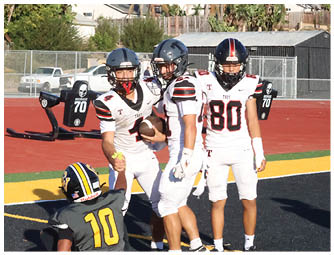 A group of football players on a field. Description generated by AI