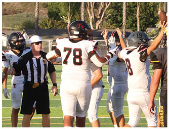 A group of football players on a field. Description generated by AI