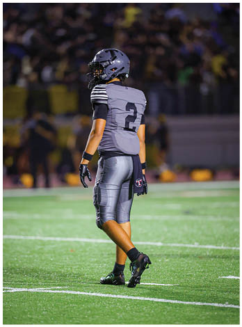 A football player wearing a blue jersey with the number 58 on it. Description generated by AI