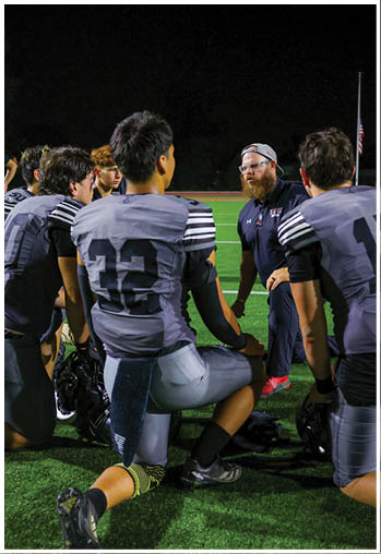 A group of football players celebrating a touchdown. Description generated by AI