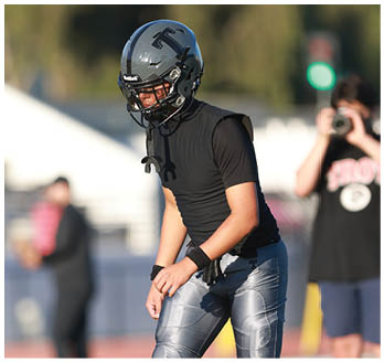 A football player running on the field. Description generated by AI