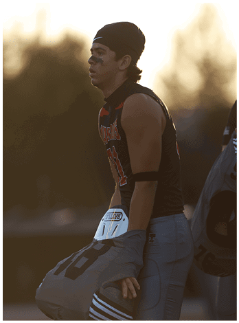 A football player wearing a blue jersey with the number 58 on it. Description generated by AI