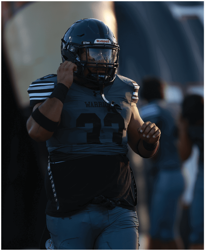 A group of football players on a field. Description generated by AI
