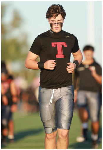 A group of football players celebrating a touchdown. Description generated by AI