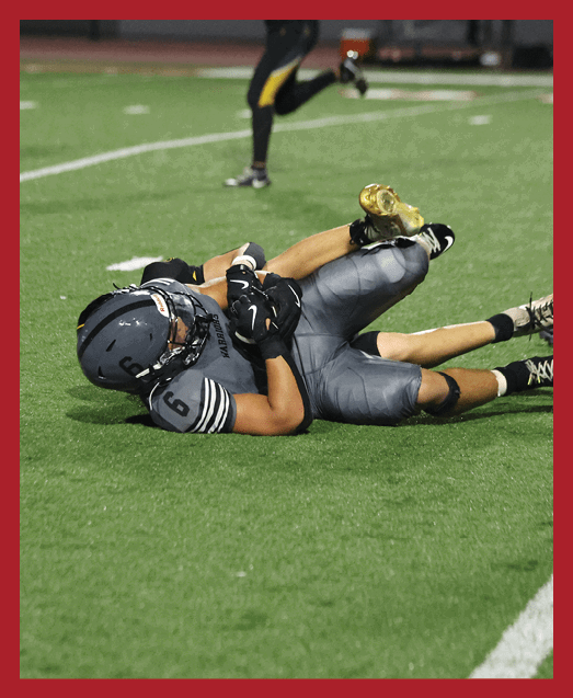 A football player in a white uniform is running with a football in his hand. AI generated content