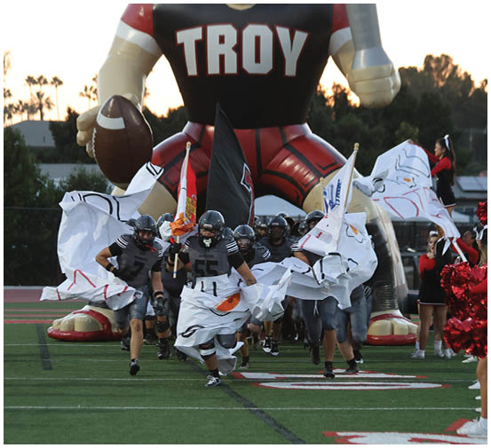 A group of football players on a field. Description generated by AI