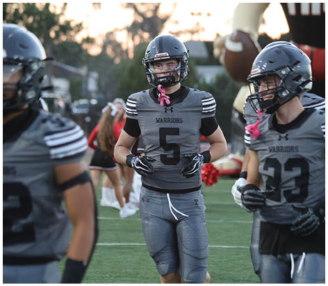 A group of football players celebrating a touchdown. Description generated by AI