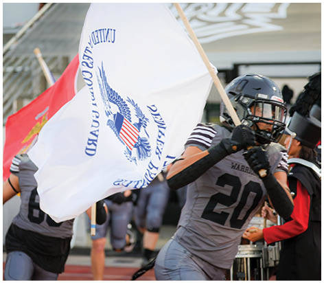 A group of football players celebrating a touchdown. Description generated by AI