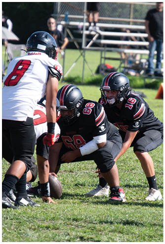 A football game is being played on a field. Description generated by AI