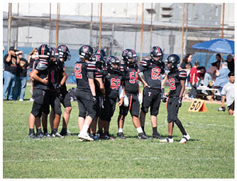 A group of football players on a field. Description generated by AI