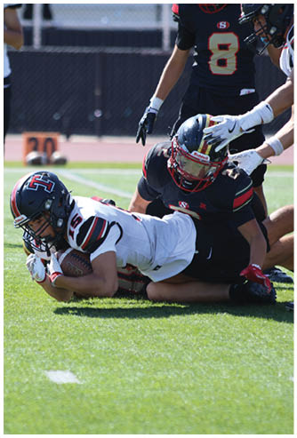 A football game is being played on a field. Description generated by AI