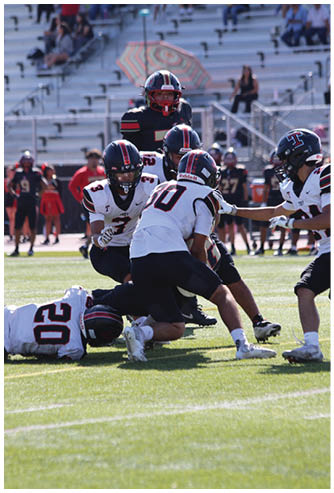 A football game is being played on a field. Description generated by AI