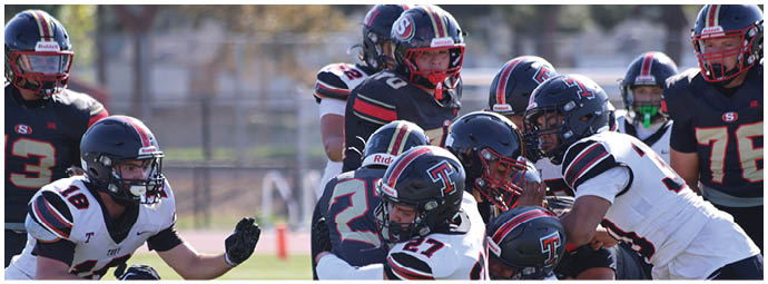 A football player wearing a blue and white uniform. Description generated by AI