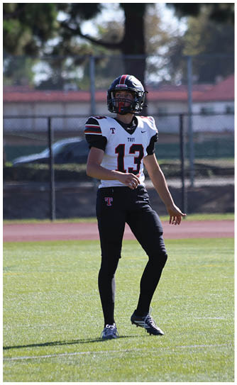 A football player catching a ball. Description generated by AI