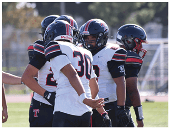 A group of football players on a field. Description generated by AI