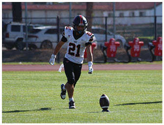 A group of football players on a field. Description generated by AI