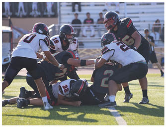 A group of football players on a field. Description generated by AI