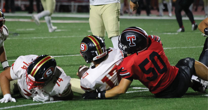 A group of people are kneeling on a field, possibly in a football game. AI generated content