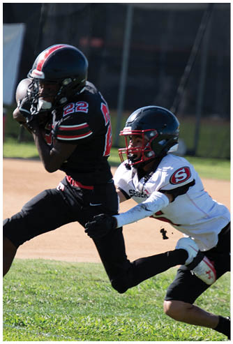 A football game is being played on a field. Description generated by AI
