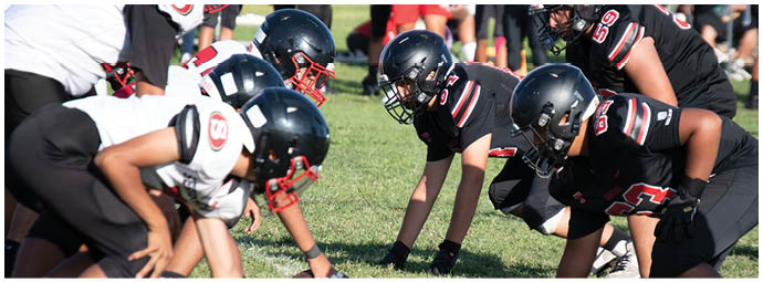 A football player wearing a blue and white uniform. Description generated by AI