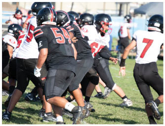 A group of football players on a field. Description generated by AI