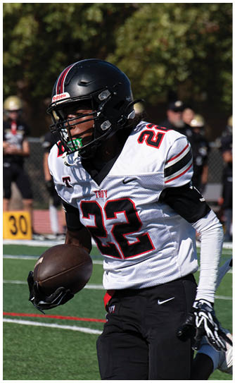A football player catching a ball. Description generated by AI