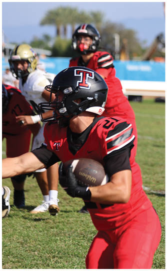 A football player catching a ball. Description generated by AI