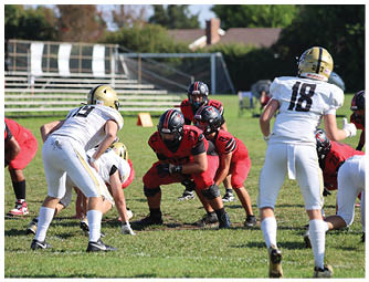 A group of football players on a field. Description generated by AI