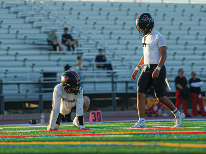 A group of football players in black and white uniforms are on the field. AI generated content
