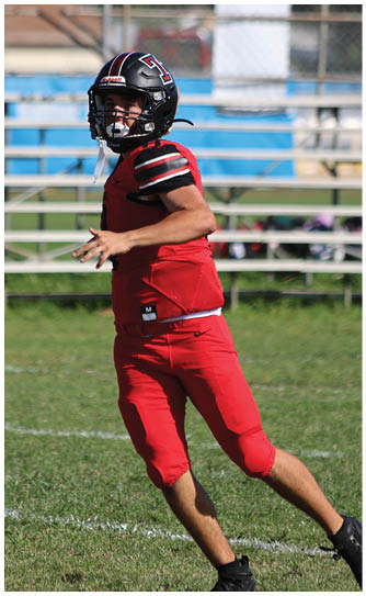 A football player catching a ball. Description generated by AI