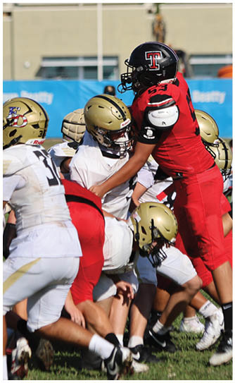 A football player catching a ball. Description generated by AI